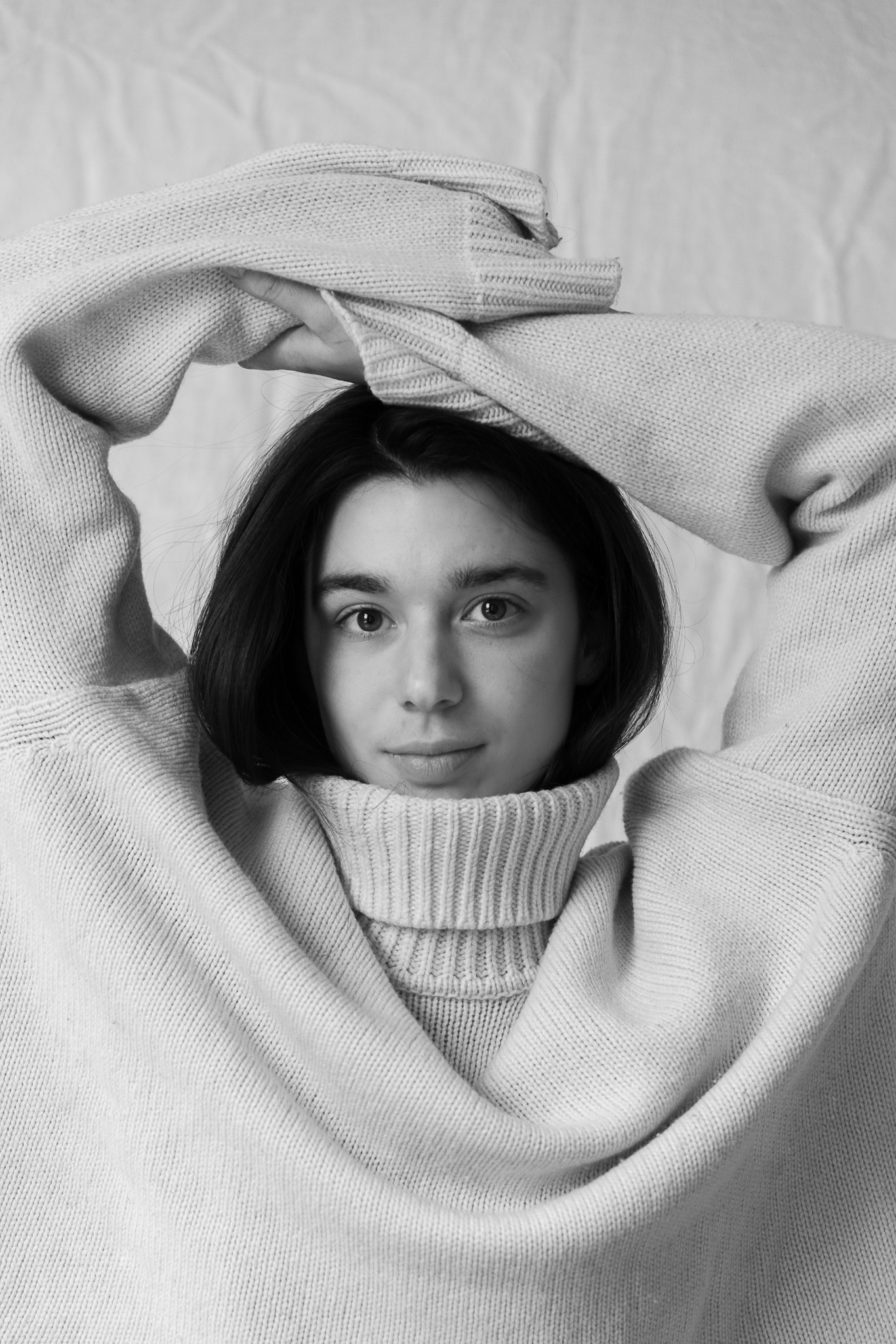 Black and white editorial portrait in an oversized knit